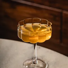 Taça de Lady Tea sobre mesa dourada