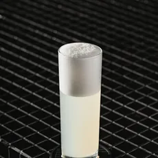 Copo alto de Pisco Fizz sobre porta-copo preto