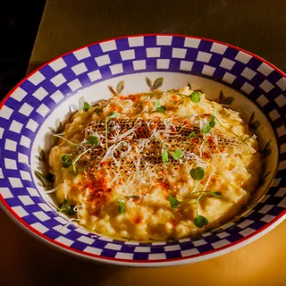 Prato de risoto de milho amanteigado com mini milho maçaricado