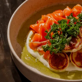 Crudo de salmão curado com blinis dourados e sour cream de iogurte